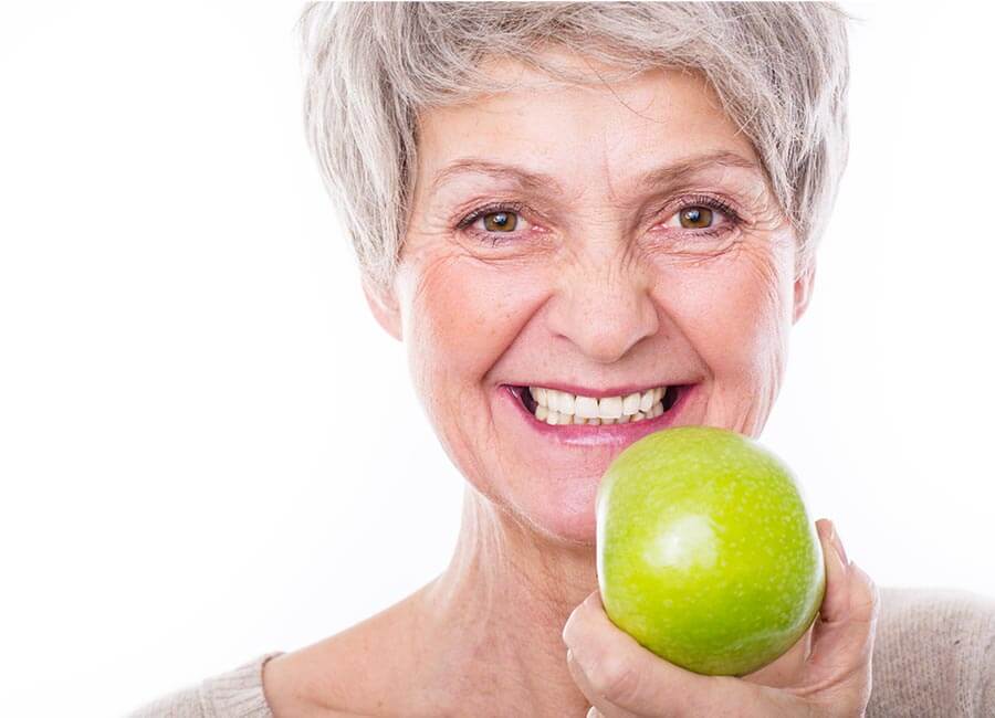 Elderly Women Eating Apple