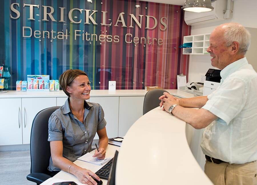 Stricklands Receptionist Interacting with Patient